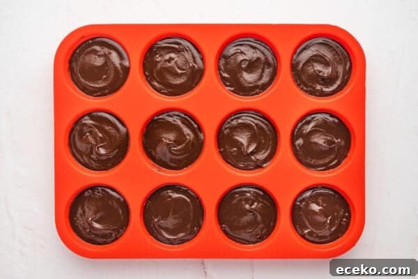 Hot Chocolate Sticks: Easy Melt-and-Serve Cocoa Treats 5 Melted chocolate in a silicone muffin pan