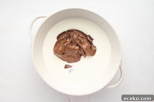 Hot Chocolate Sticks: Easy Melt-and-Serve Cocoa Treats 4 Heavy cream and nutella in a bowl