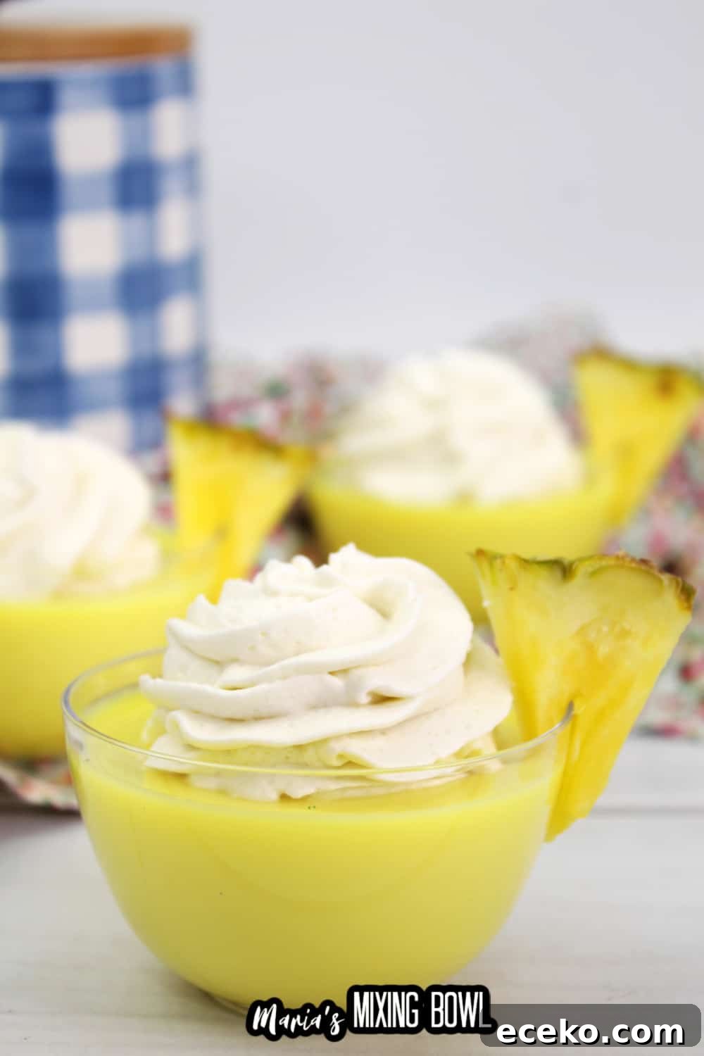 Dole Whip Shot Recipe: How to Make the Creamy Tropical Cocktail 6 dole whip shot in a small glass bowl garnished with a slice of pineapple