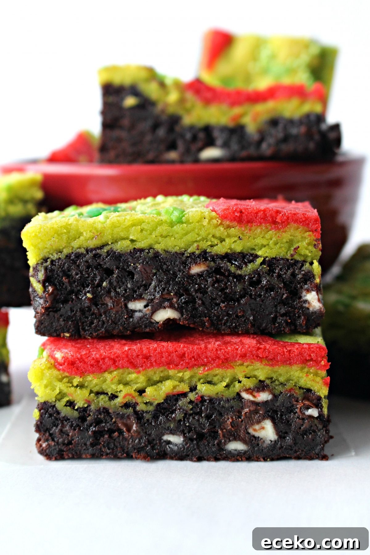 A stack of two Grinch Brownies, brownie on the bottom and green and red blondie on the top.