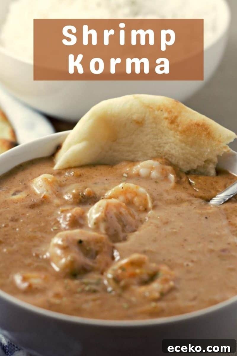 Creamy Shrimp Korma Recipe with Aromatic Spices 9 a bowl filled with Shrimp Korma and a slice of naan bread.