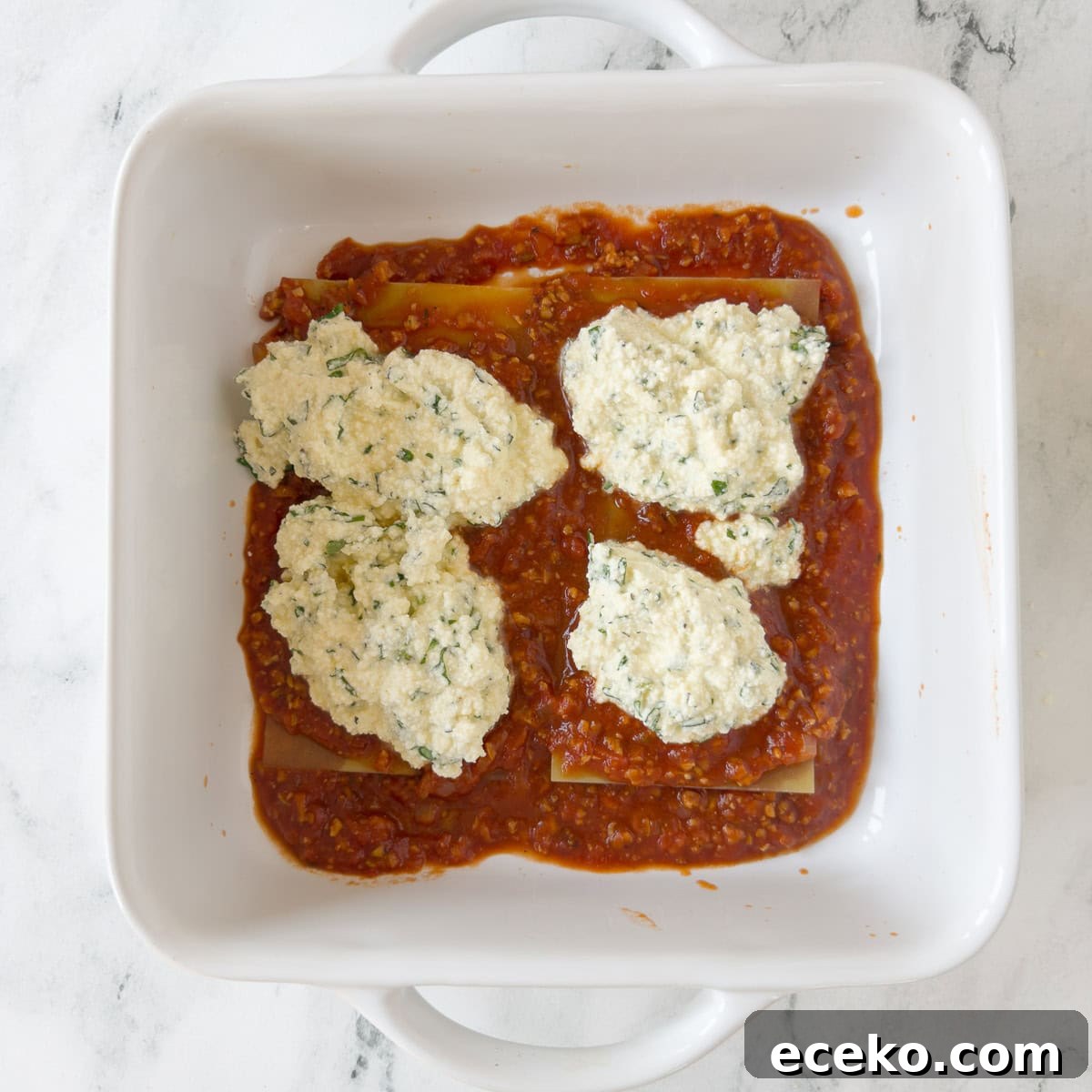 Gluten free lasagna layer with oven ready noodles, and sauce, with ricotta cheese topping.