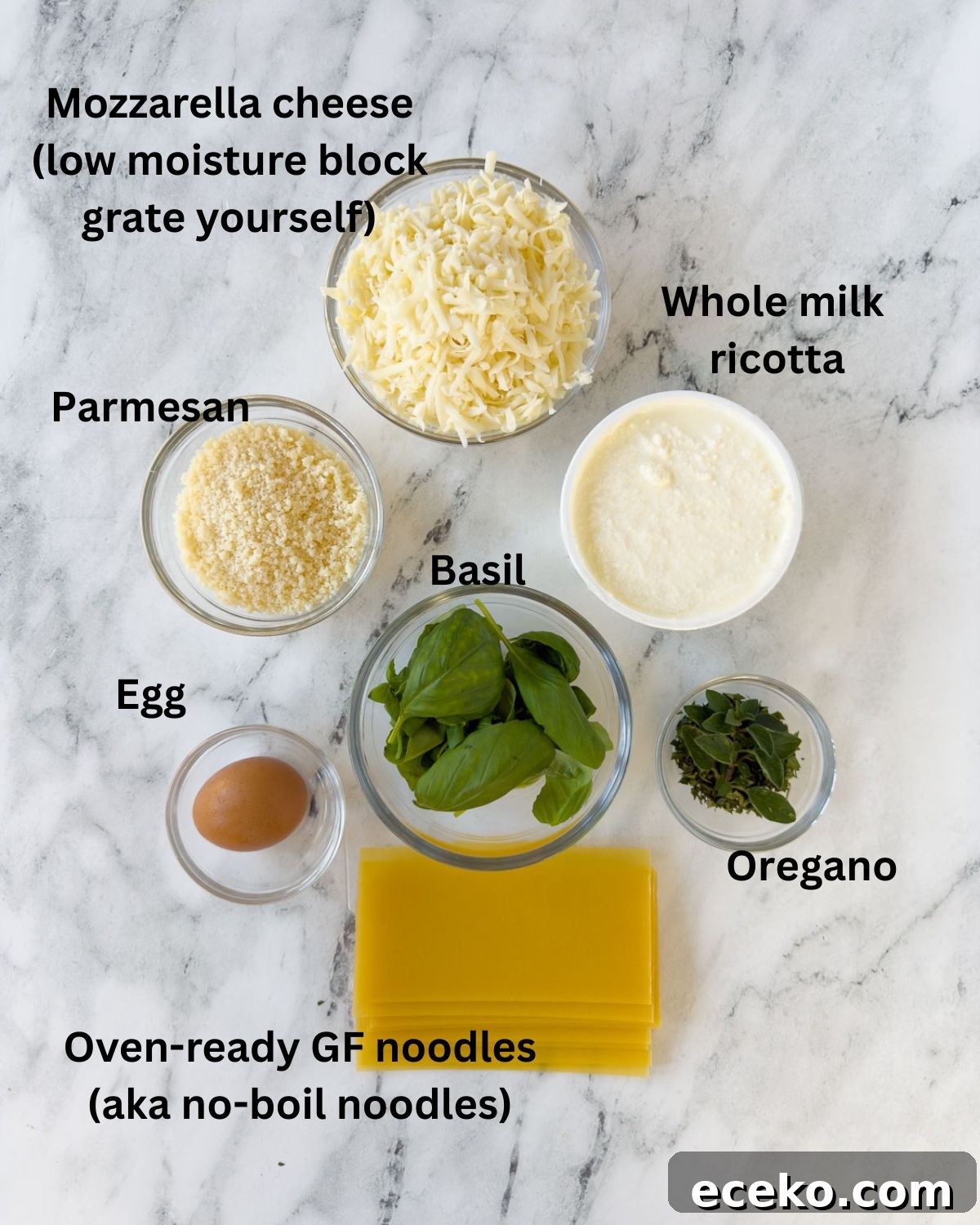 Ingredients for gluten-free lasagna filling with ricotta, parmesan, egg, herbs, and noodles. 