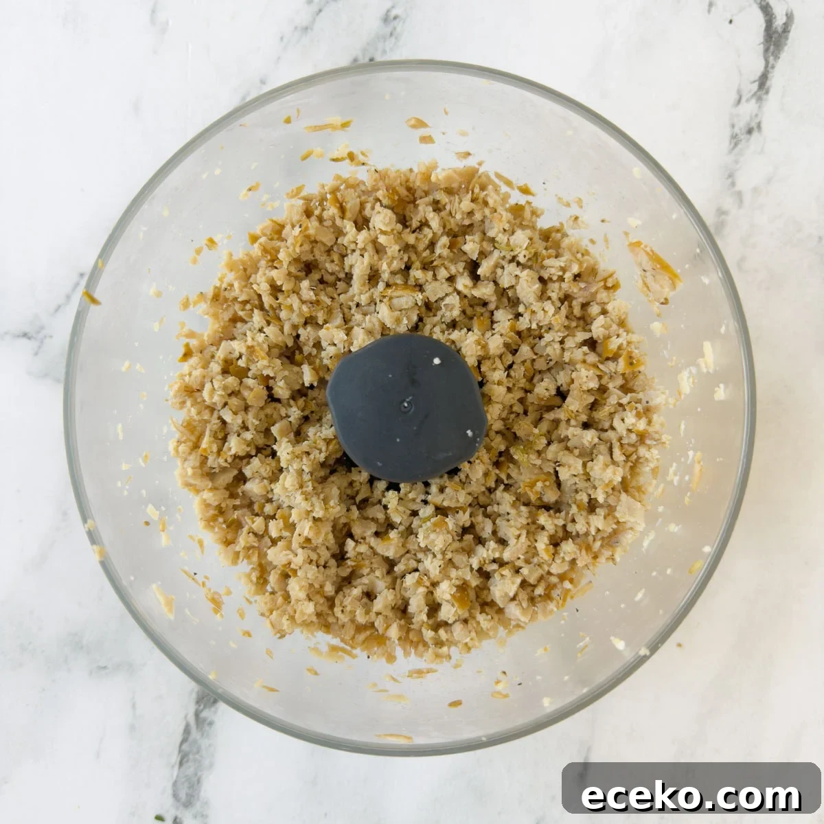 Ground sausage in a food processor workbowl. 