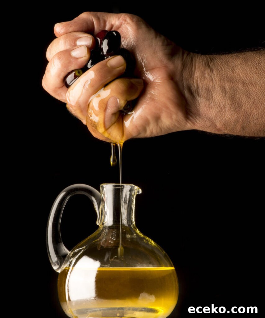 Cooking Oils to Avoid and Healthier Alternatives 2 Hand squeezing oil from olives