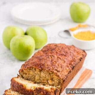 A loaf of apple cheddar bread with slices cut on the end