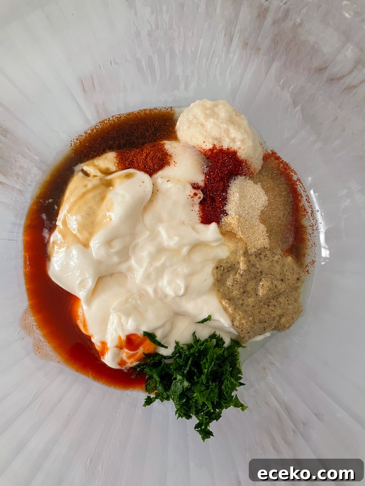 Authentic New Orleans Remoulade Sauce Recipe for Seafood 4 New Orleans remoulade sauce ingredients in glass bowl.