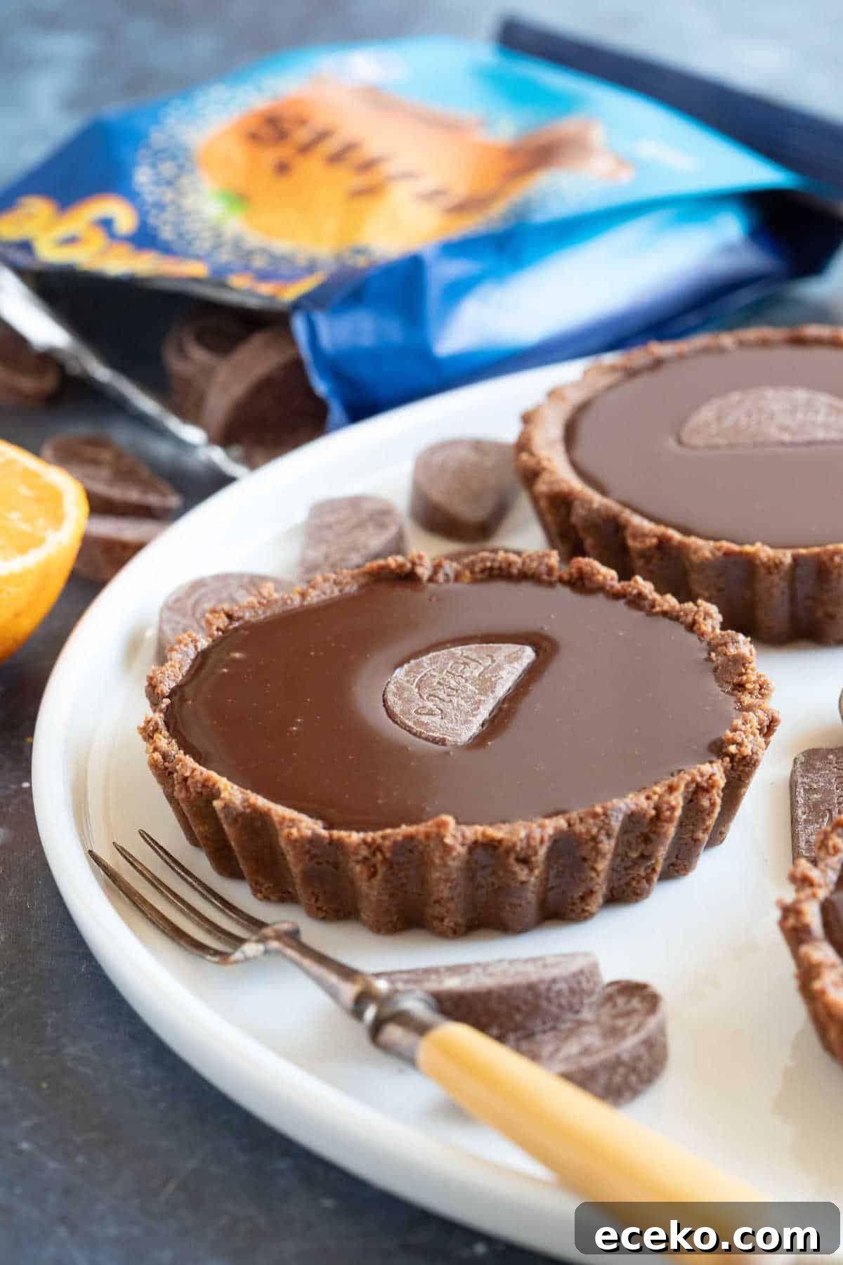 No-Bake Terry’s Chocolate Orange Mini Tarts 2 No bake chocolate orange tarts on a serving platter.