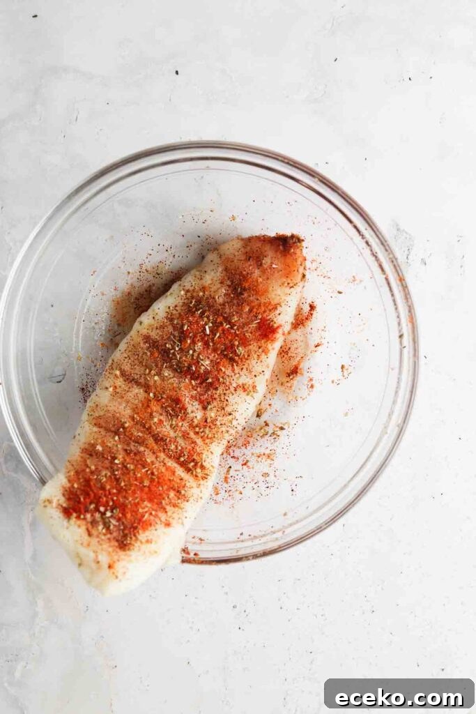blackened seasoning and cod in a bowl mixed