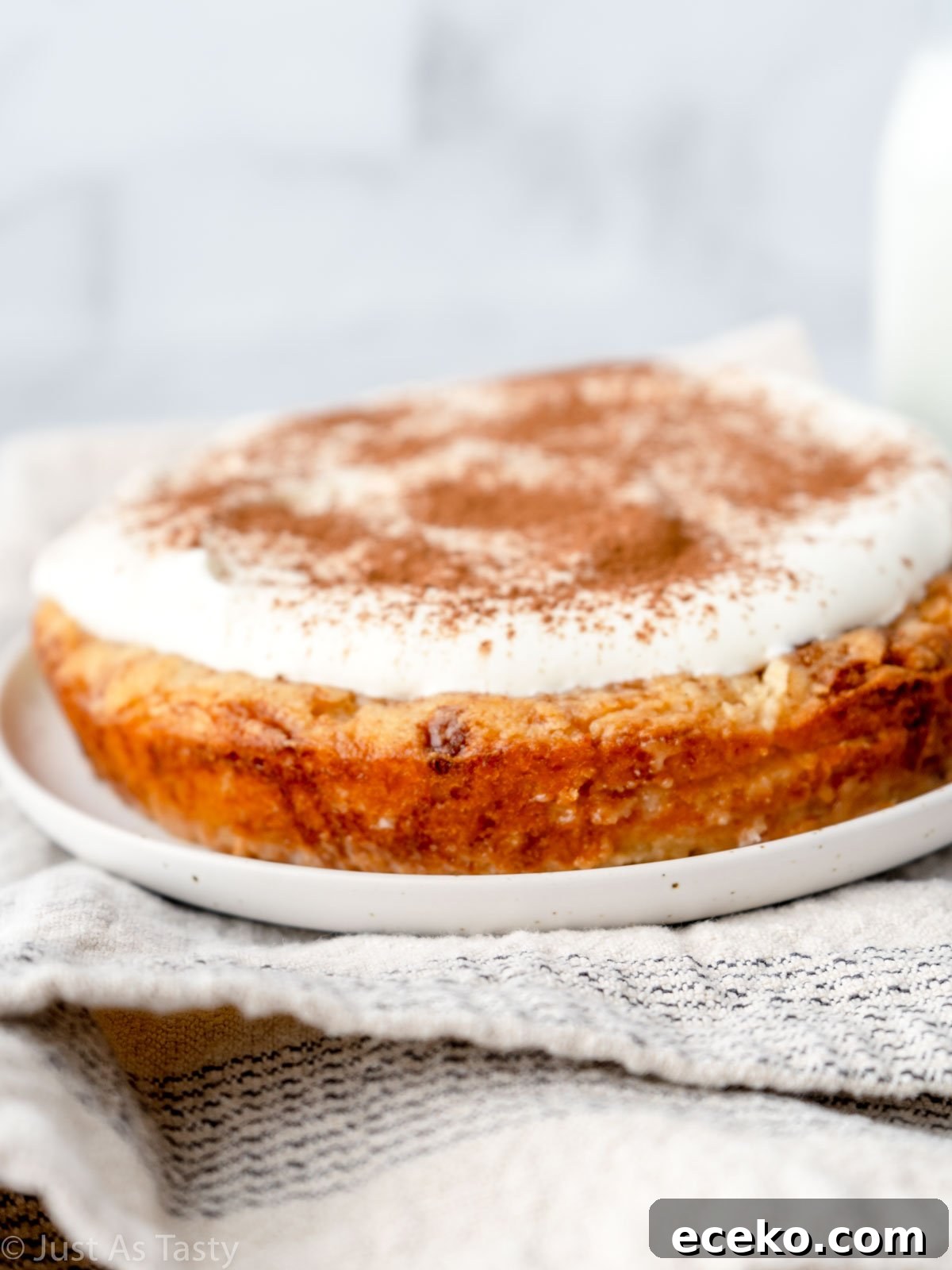 Gluten free tres leches cake on a white plate. 
