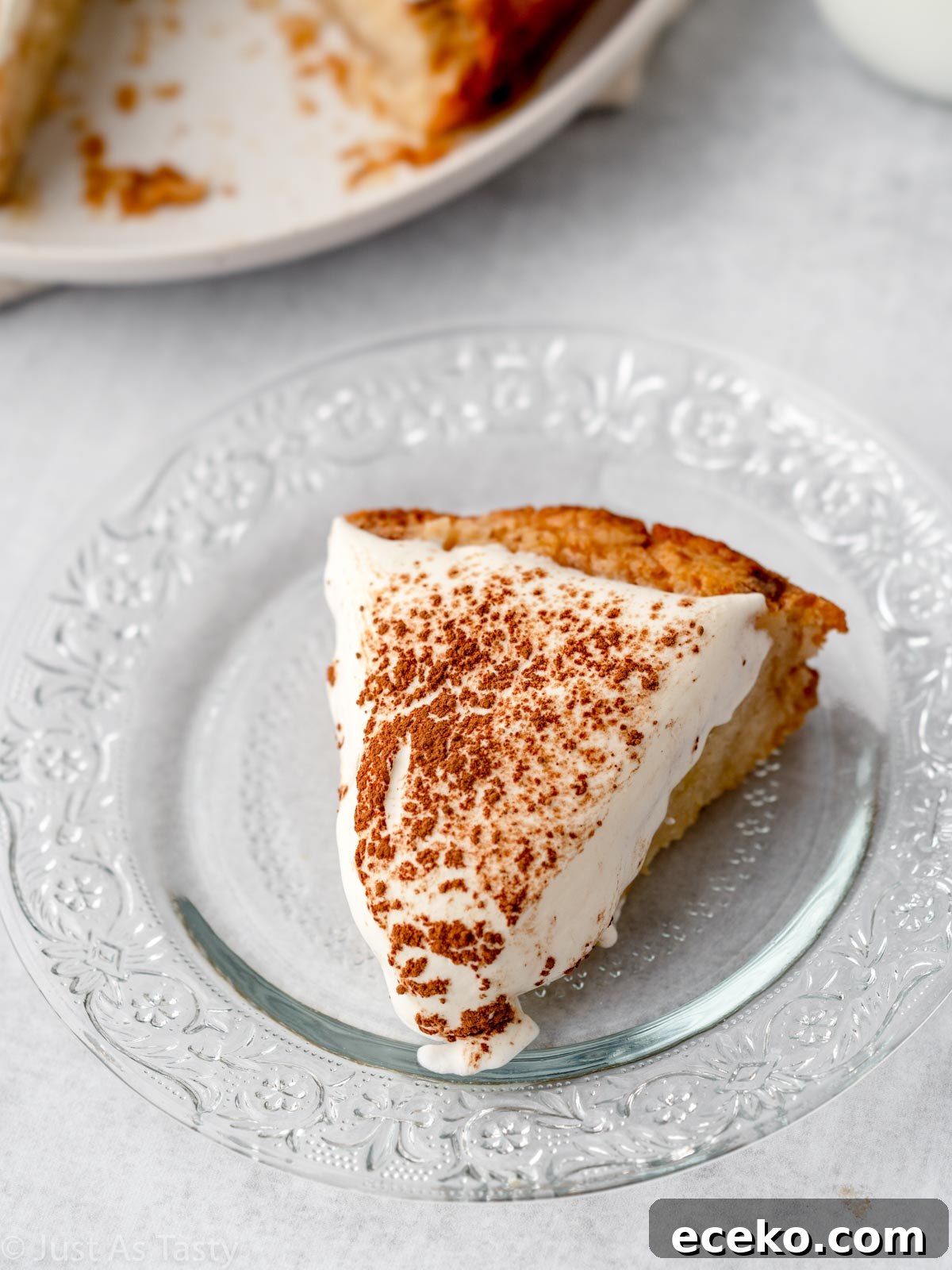 Slice of gluten free tres leches cake on a glass plate. 