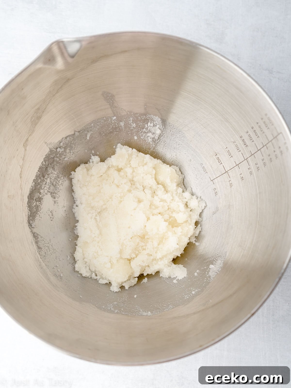 Sugar and oil combined in a mixing bowl.