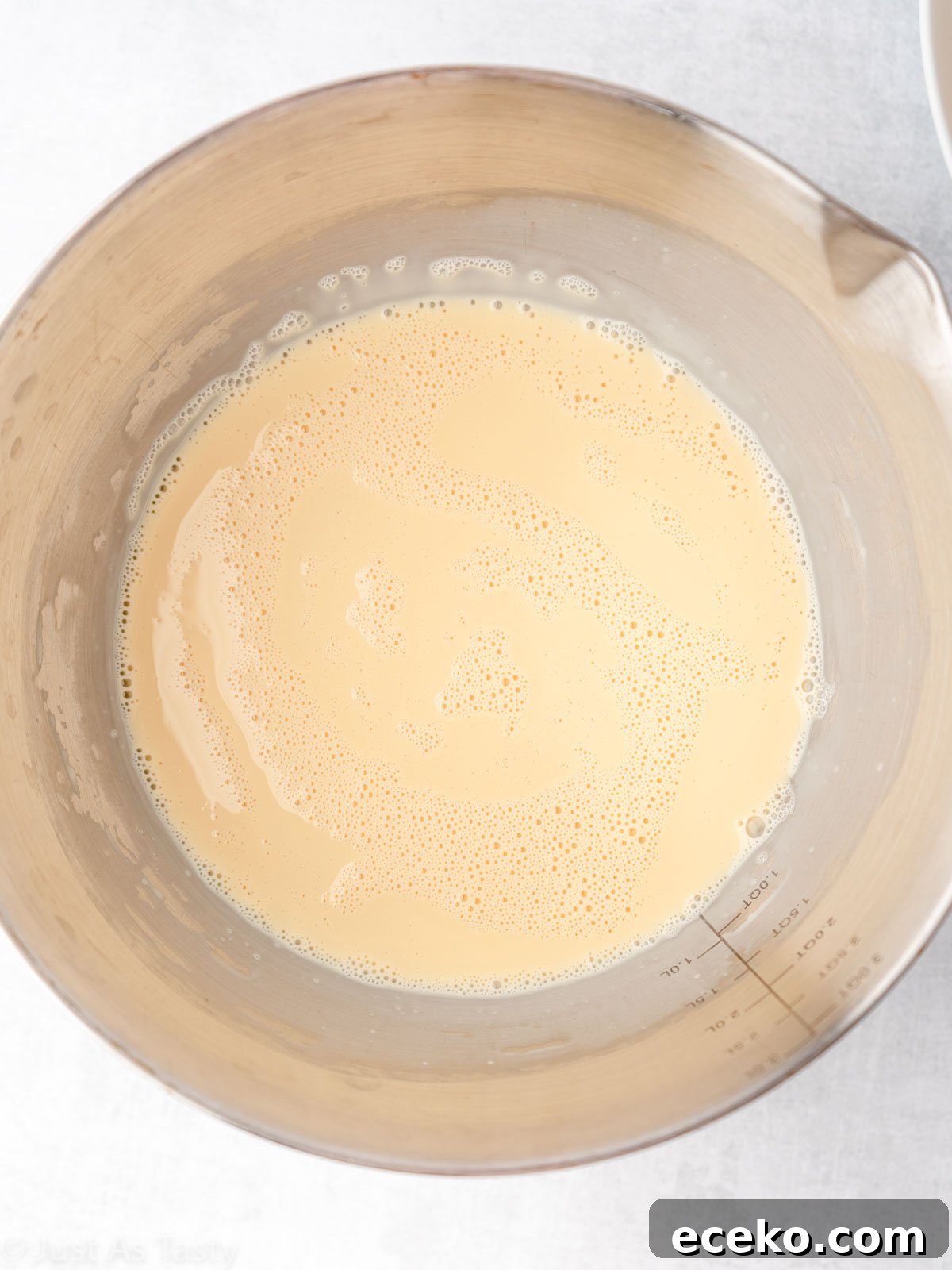 Three milk mixture for tres leches cake in a bowl.