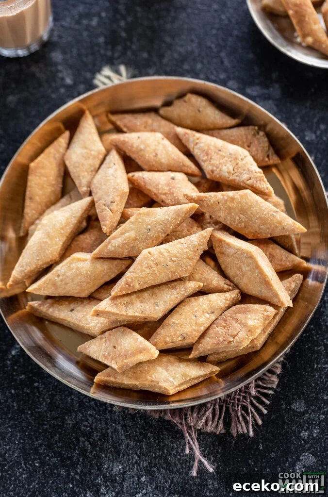 diamond shape namak para served in a bronze plate