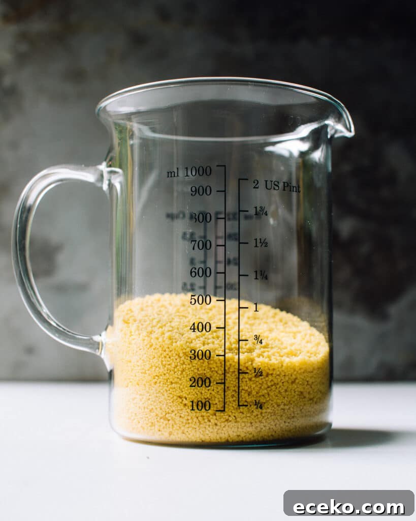 dry couscous in a measuring cup.