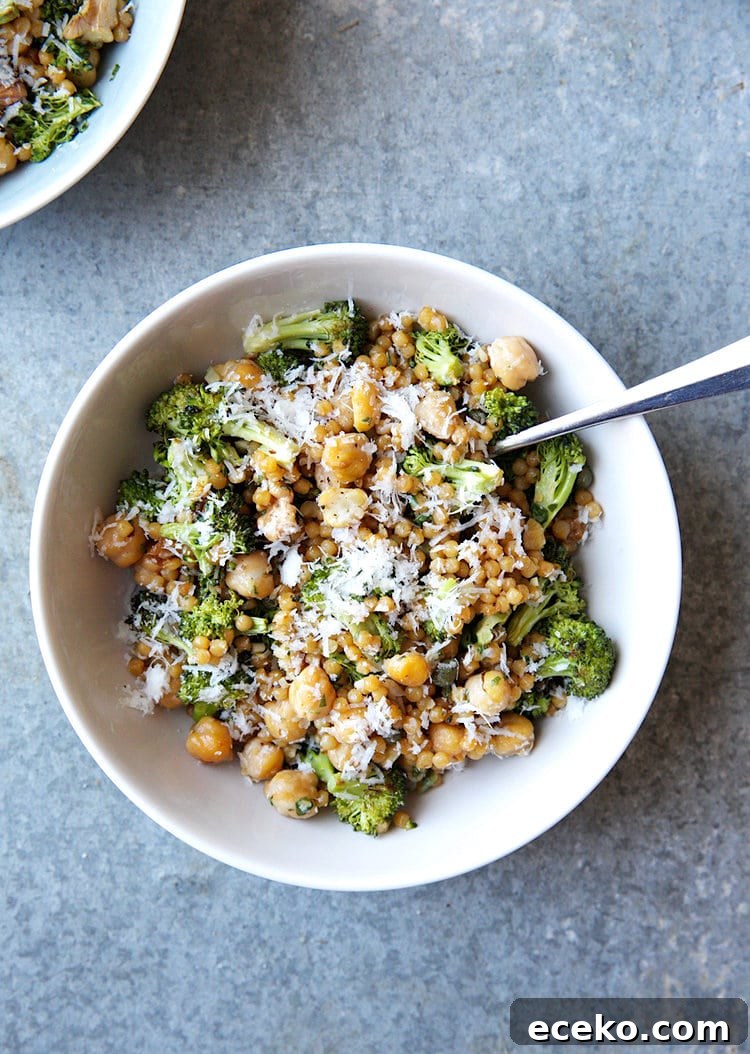 Israeli couscous salad with chickpeas and broccoli on a plate.
