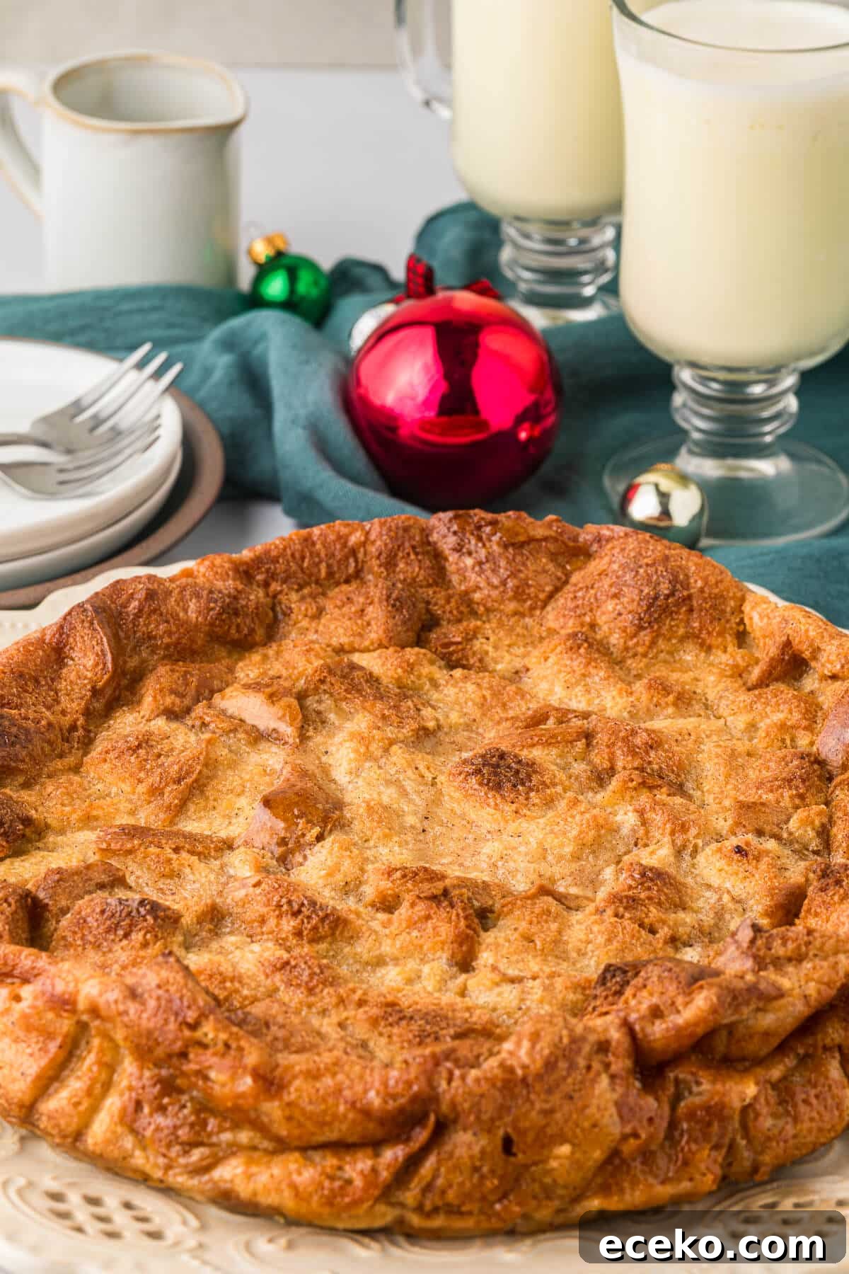 Eggnog Bread Pudding with Cinnamon-Caramel Sauce 2 Eggnog bread pudding on a plate.