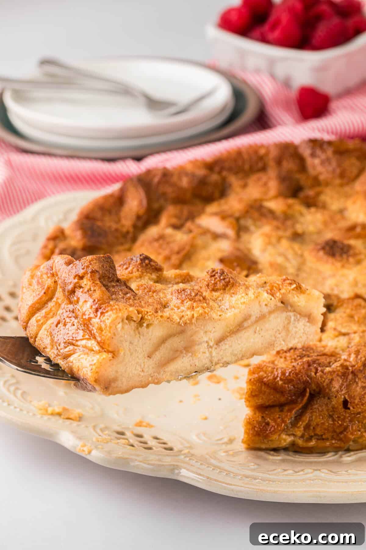 Eggnog Bread Pudding with Cinnamon-Caramel Sauce 5 A slice of eggnog bread pudding on a spatula.