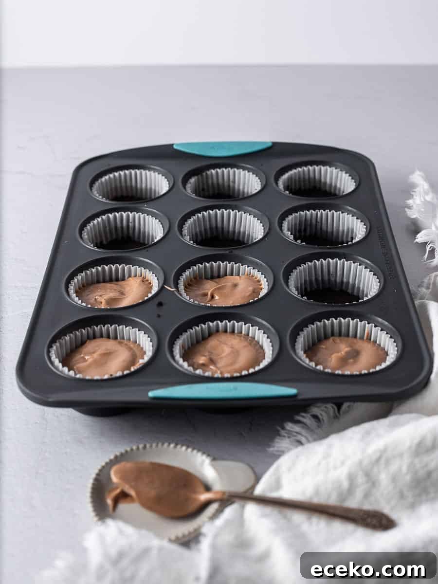 Mini Chocolate Cheesecakes with Rich Ganache Topping 4 cheesecake batter placed into the cupcake tins