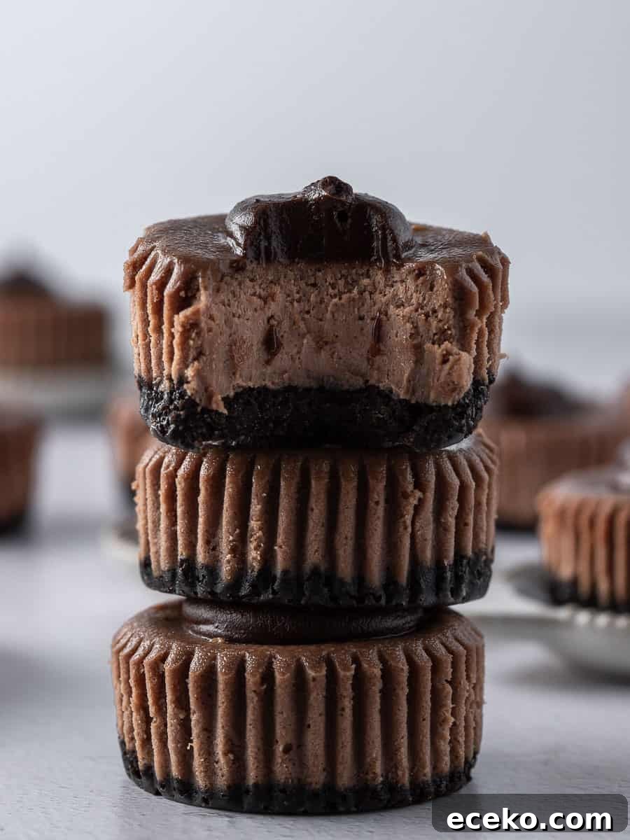 Mini Chocolate Cheesecakes with Rich Ganache Topping 6 3 mini chocolate cheesecakes stacked on top of each other with a bite out of one