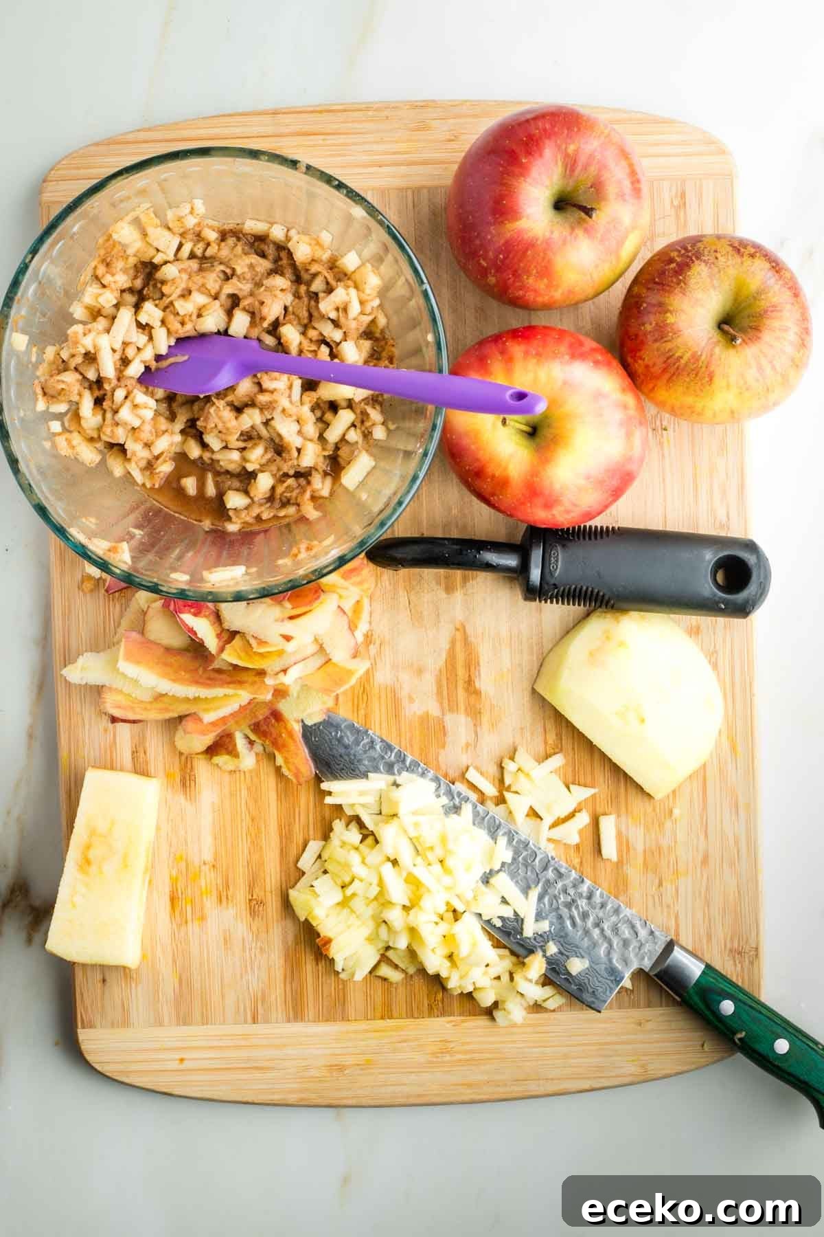 Vegan Apple Pie Bars with Cinnamon Streusel 17 Dicing apples into small pieces and adding them to a bowl with spices in lemon juice.