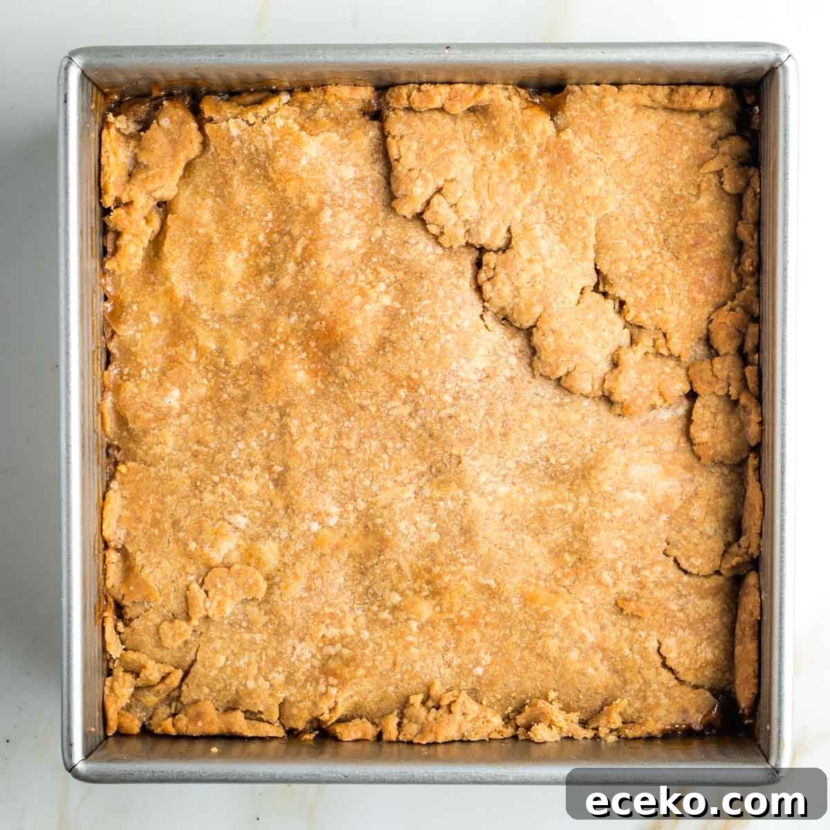 Vegan Apple Pie Bars with Cinnamon Streusel 20 Baked pie with top dough in a square pan.