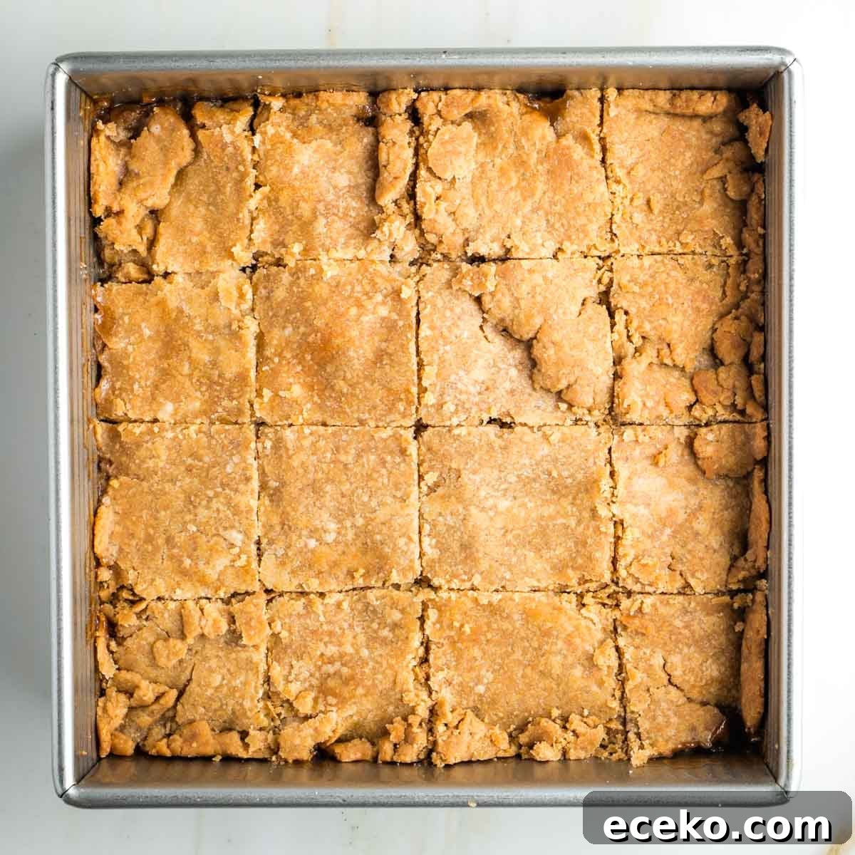 Vegan Apple Pie Bars with Cinnamon Streusel 21 Square pan of pie with top dough, cut into squares.