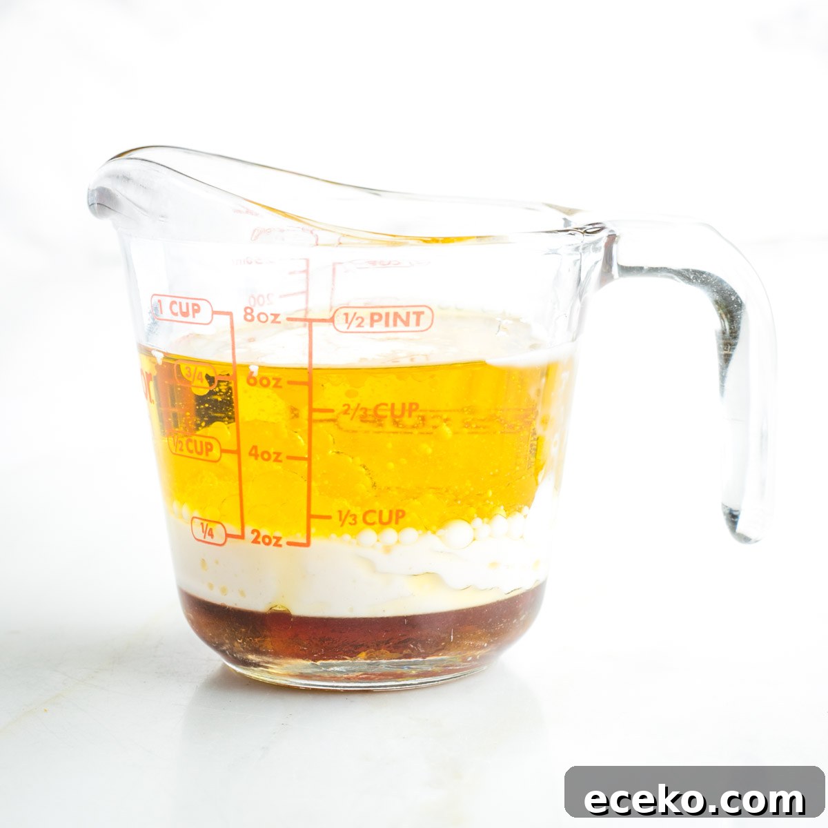Vegan Apple Pie Bars with Cinnamon Streusel 4 Pyrex measuring cup with olive oil, almond milk and maple syrup.