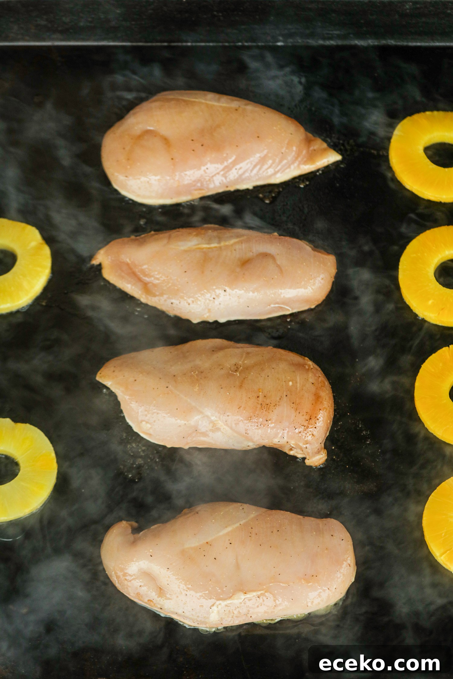 Sweet and Smoky Grilled Pineapple Chicken Recipe 6 Chicken searing on a griddle with pineapple