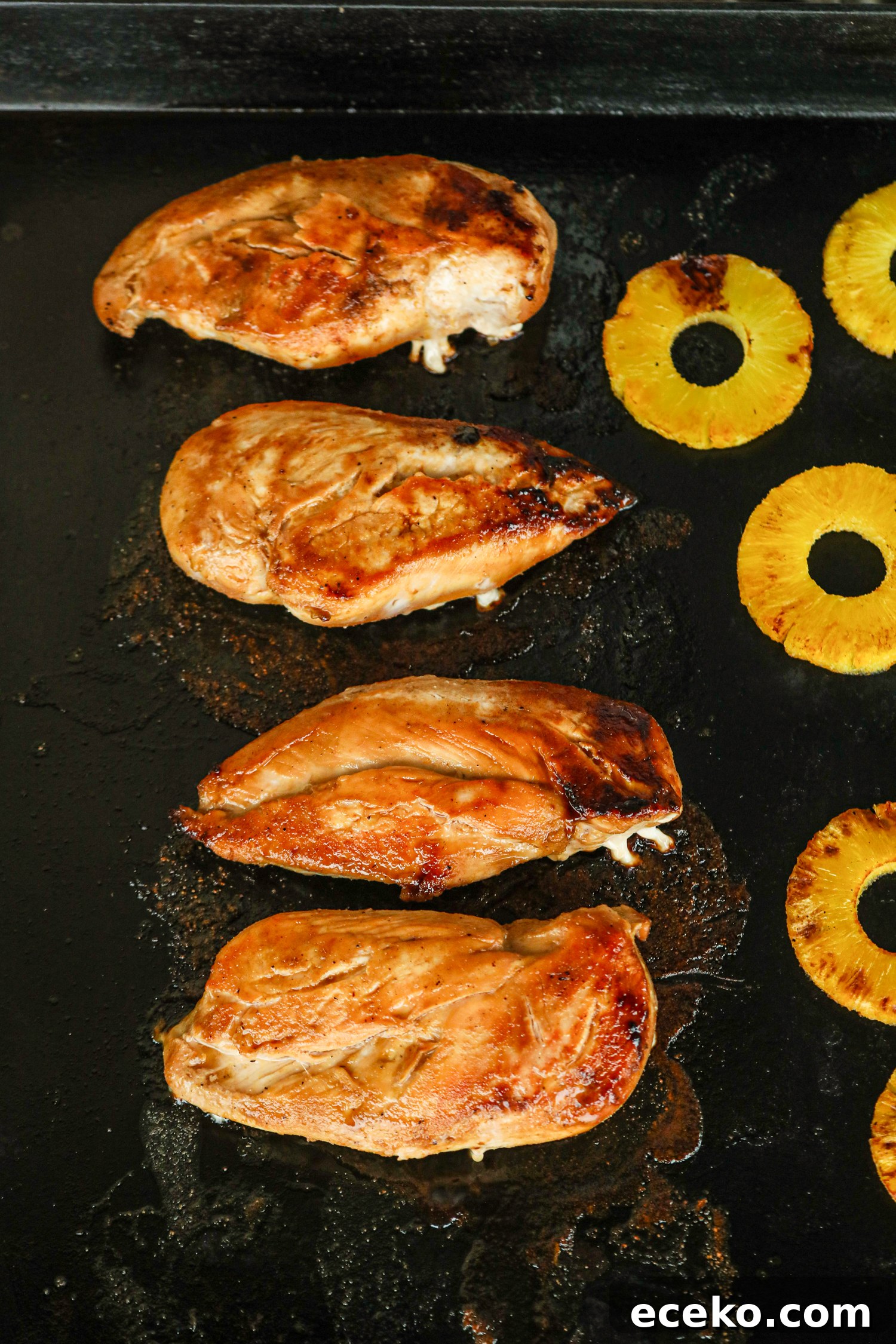 Sweet and Smoky Grilled Pineapple Chicken Recipe 7 Grilled chicken breasts and pineapple slices on a griddle