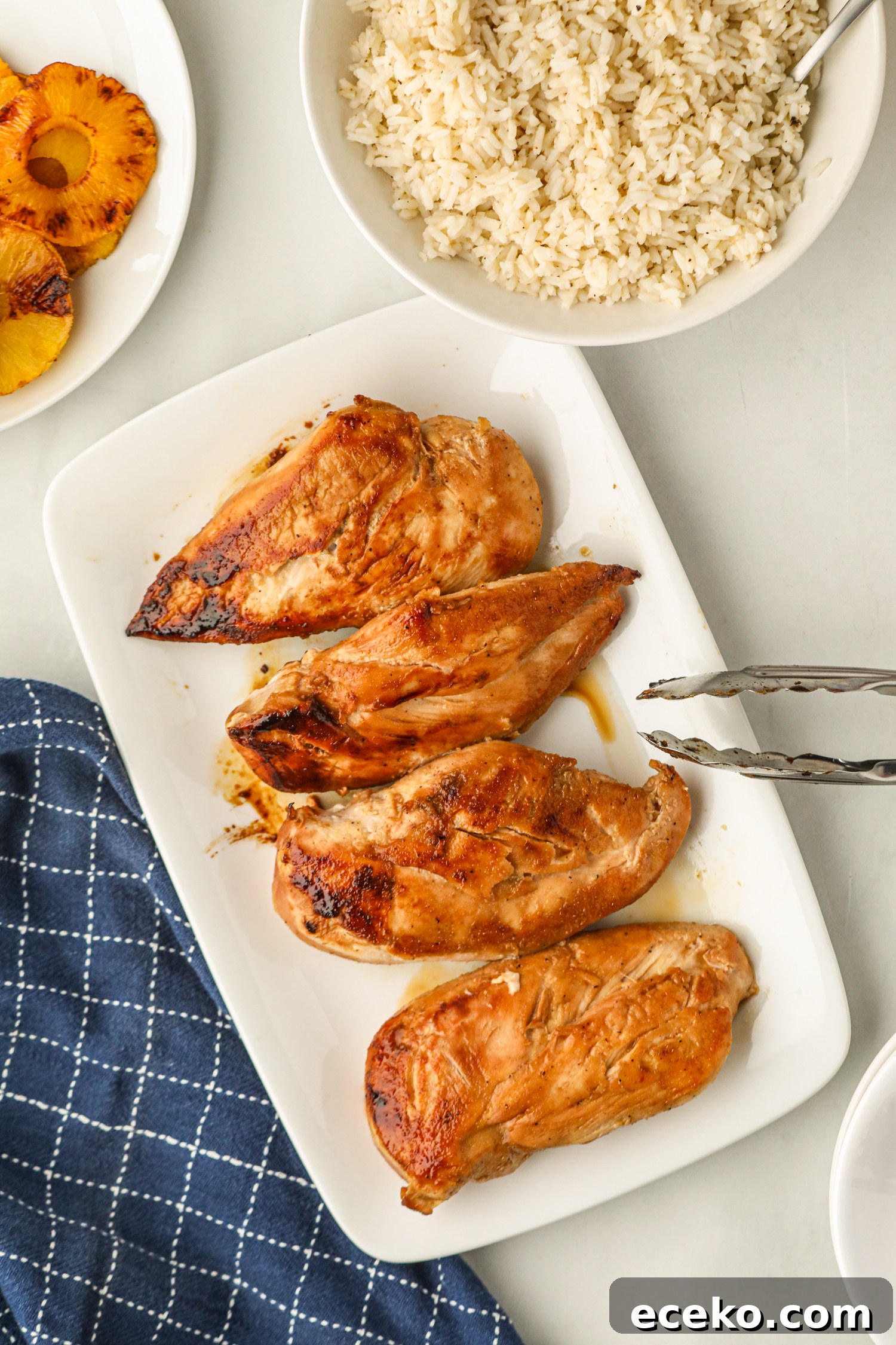 Sweet and Smoky Grilled Pineapple Chicken Recipe 9 Plated grilled chicken breasts with a bowl of rice and grilled pineapple slices