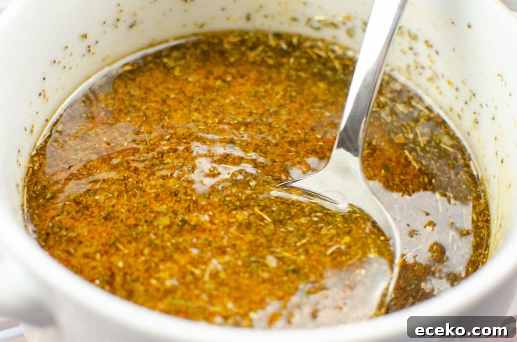 Olive and Herb Focaccia Bread Recipe 8 mixing the olive oil, sundried tomato puree and dried herbs together in a bowl using a spoon