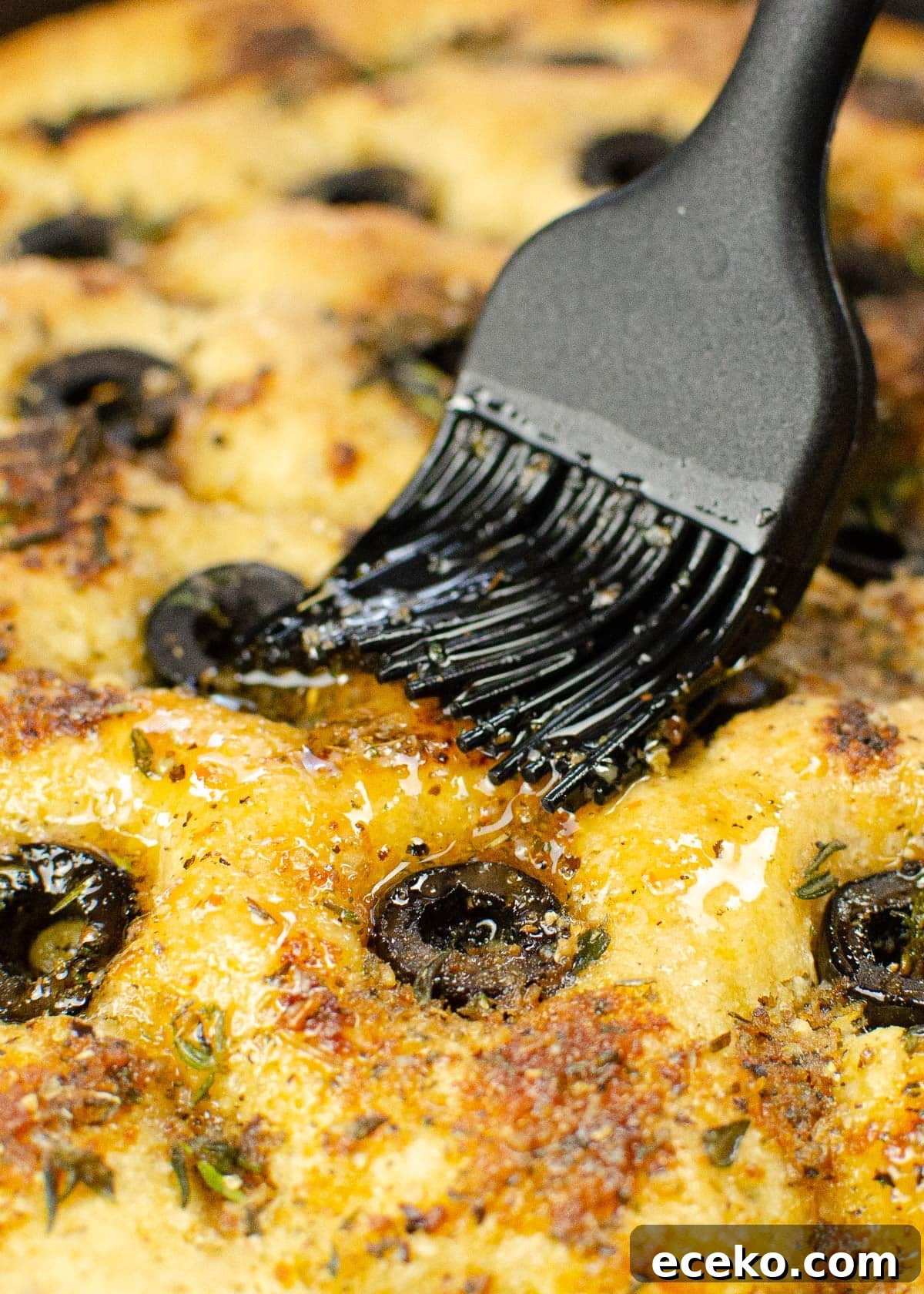 Olive and Herb Focaccia Bread Recipe 4 Coating our olive focaccia bread with olive oil mixture
