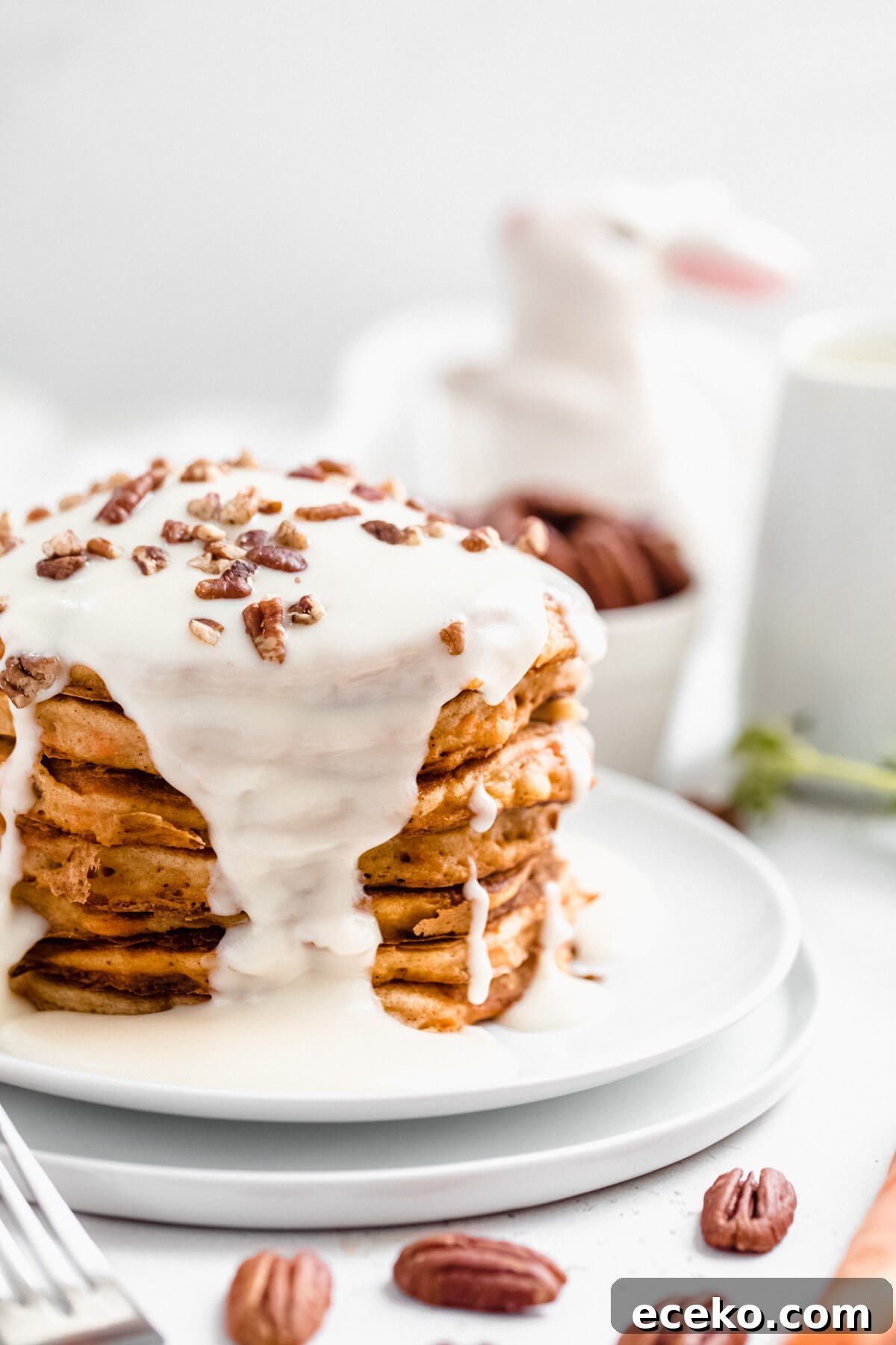 Carrot Cake Pancake Recipe with Cream Cheese Glaze 7 close up of a stack of pancakes on double white plates