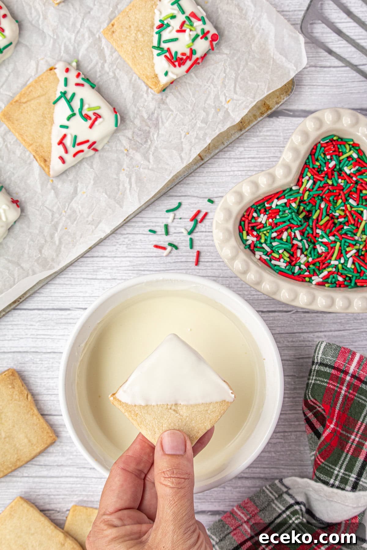 Hawaiian Shortbread Cookies with Coconut and Macadamia 7 Dipping the baked shortbread cookies into melted white chocolate.
